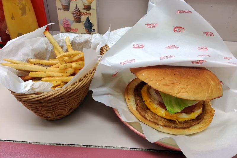 A food-focused photo of a burger and fries in a restaurant setting.