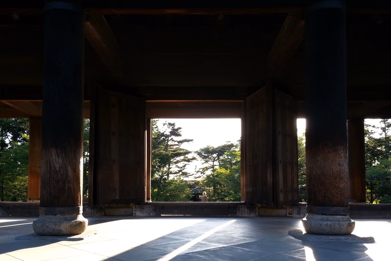 A photo of a wooden frame with an open view of trees in the background.