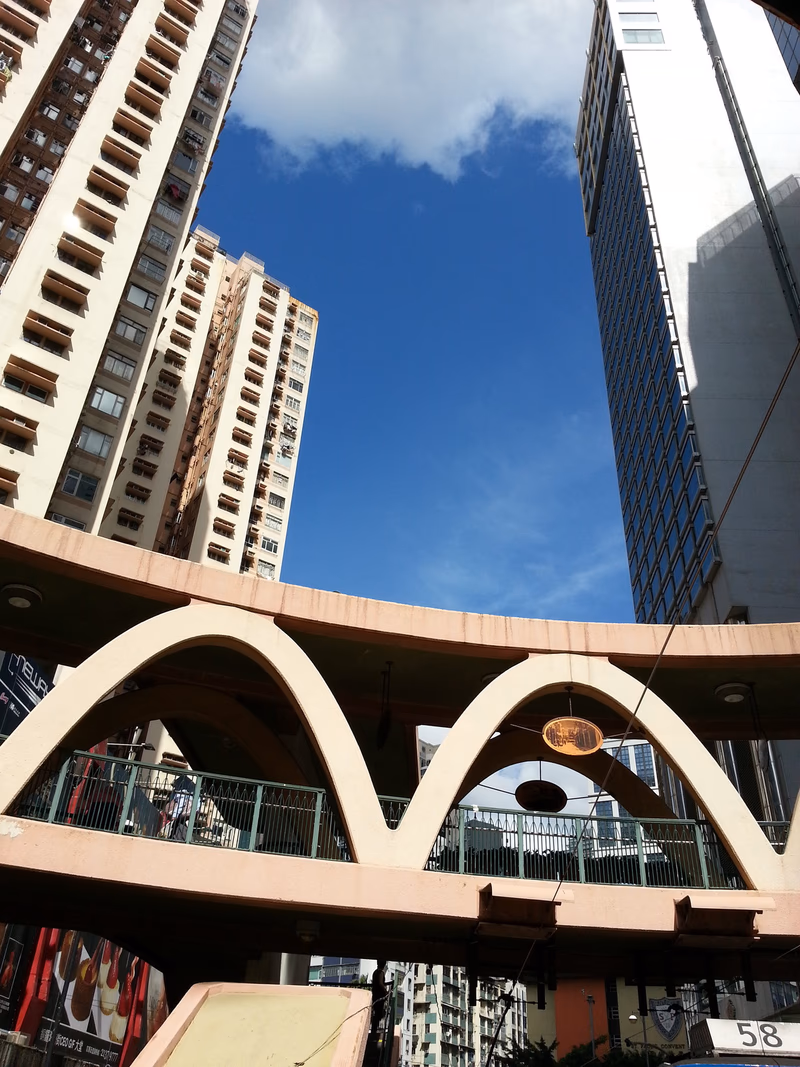 Aerial view of a city with tall buildings and a bridge in the foreground.