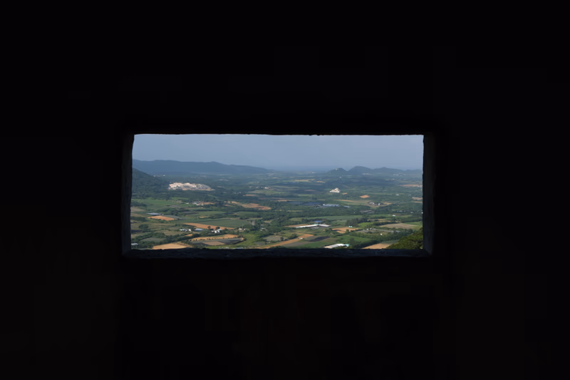 A view of a landscape taken through a rectangular window