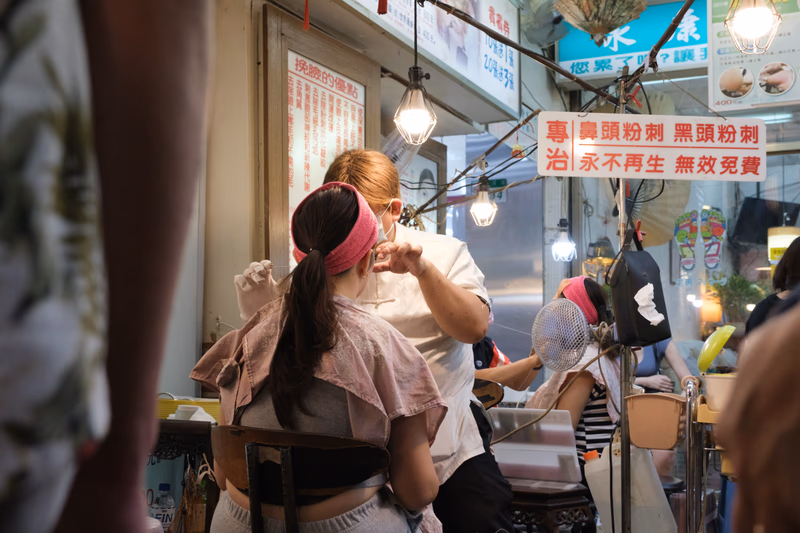 A woman is getting her hair done at a beauty salon.