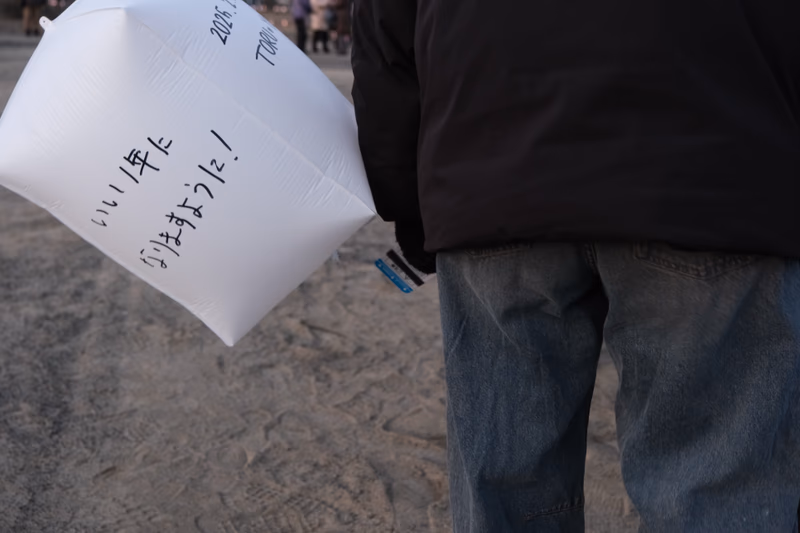 A plastic bag with Japanese text on it, held by a person.