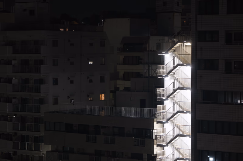 A night view of a building with illuminated stairs.