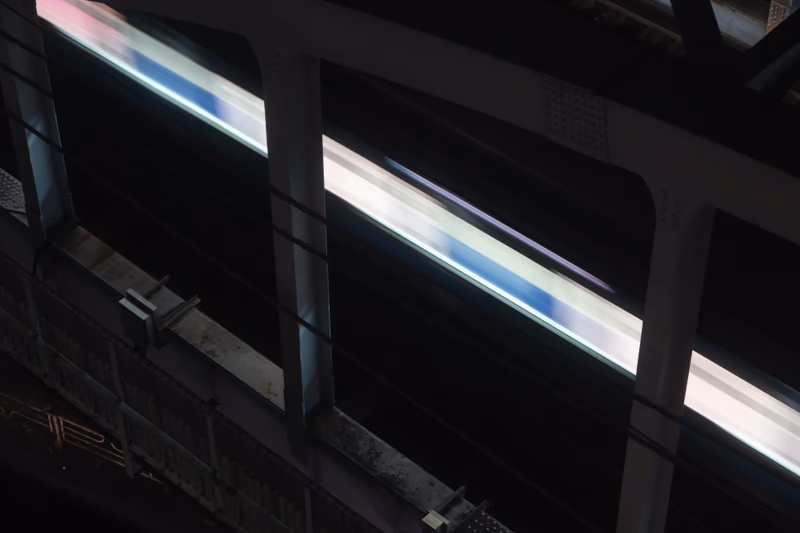 A photograph of a train passing by a station in Yokohama, Japan.