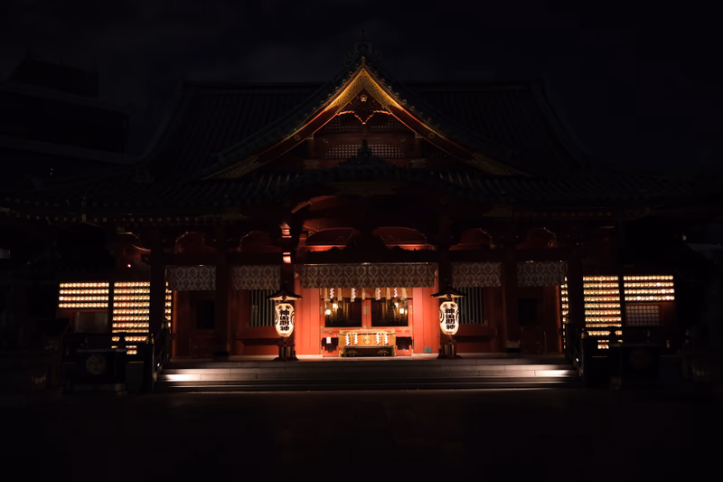 A nighttime view of a traditional Japanese temple in Akihabara, Tokyo.
