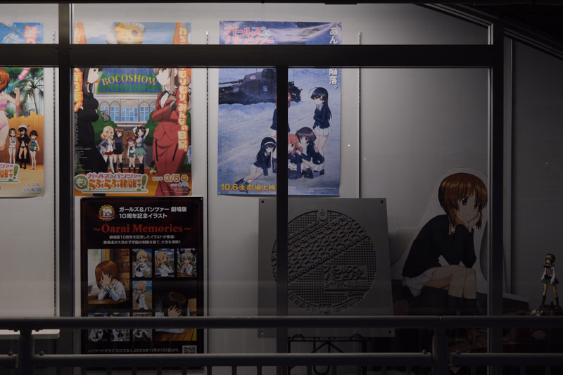 A display of anime posters, including one for "Bocoshow" and another advertising an event on "10.6".