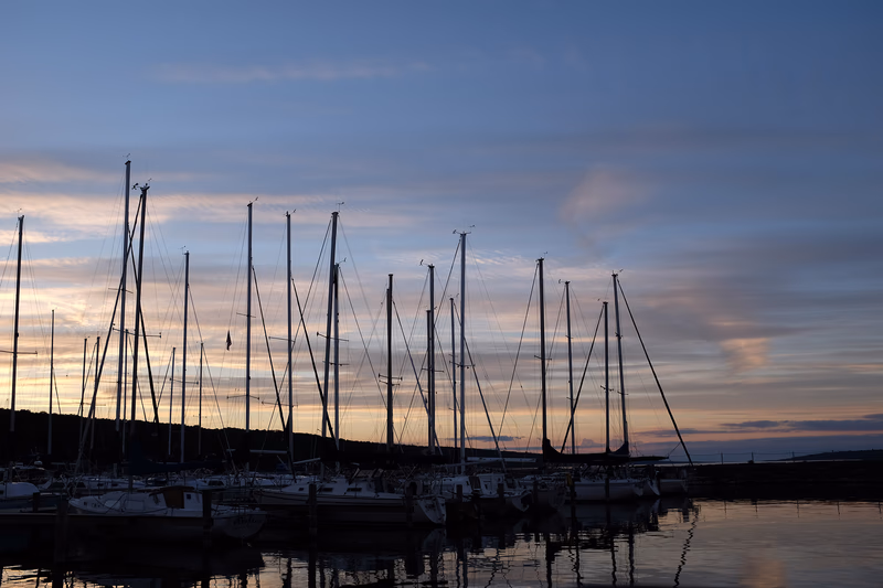 A serene sunset over a dock with boats