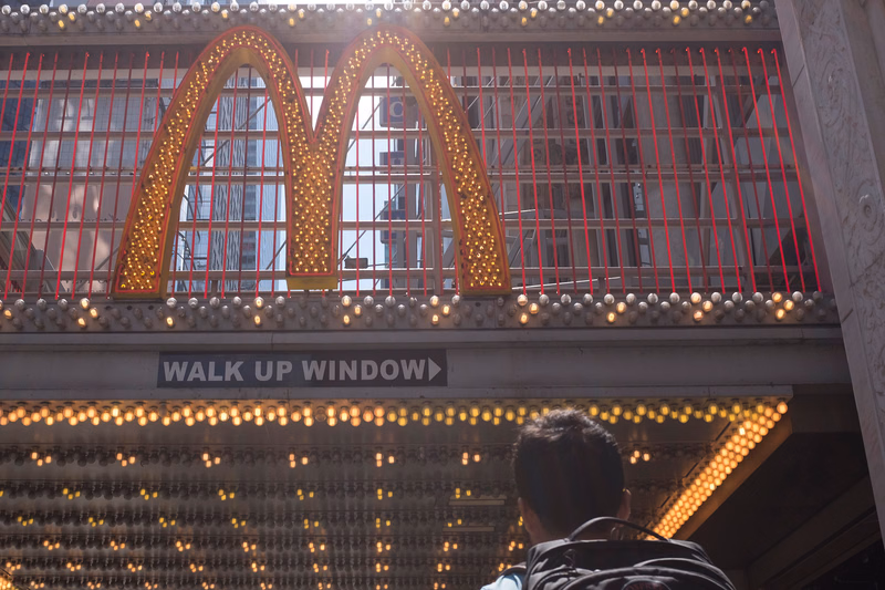 The McDonald's sign featuring three golden arches is visible above a window labeled "WALK UP WINDOW".