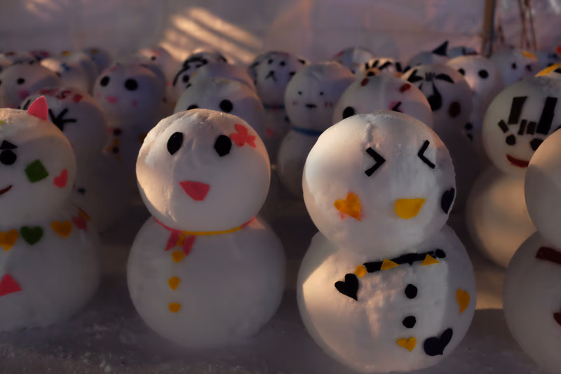 A collection of intricately decorated snowmen with various facial expressions.