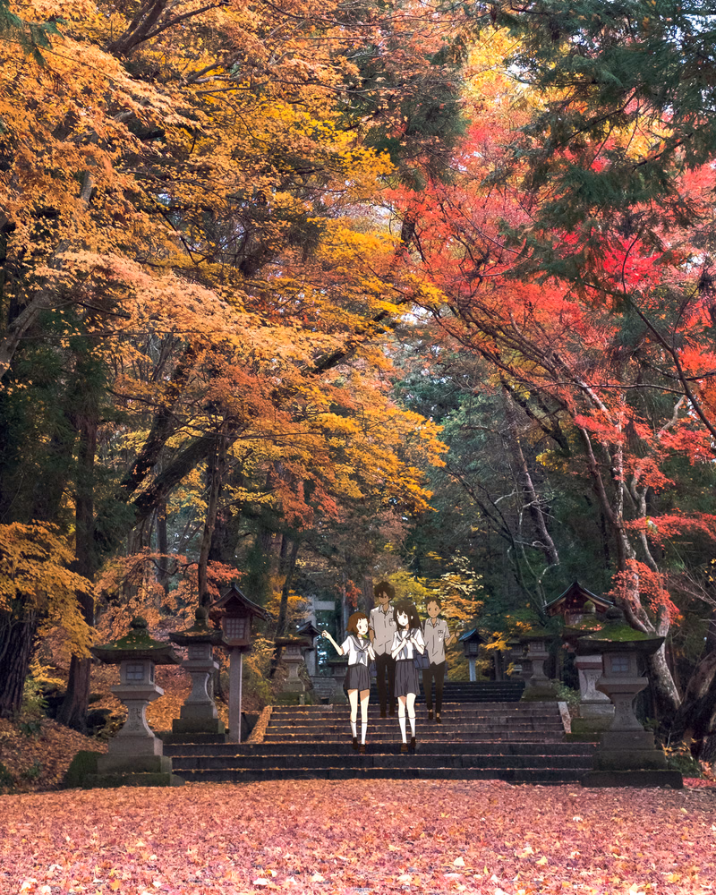 Two women in school uniforms stand on stone steps surrounded by vibrant autumn foliage in a Japanese garden setting.