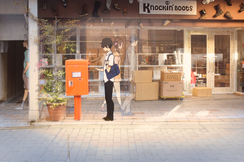 A street view of a Knockin' Boots store featuring mannequins and an orange mailbox outside the glass windows.