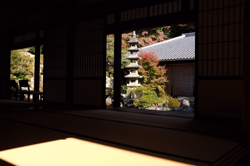 A serene view of a traditional Japanese garden with a pagoda in the background.