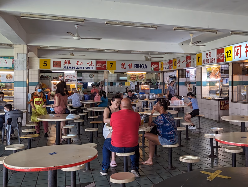 A busy restaurant with people eating and chatting.