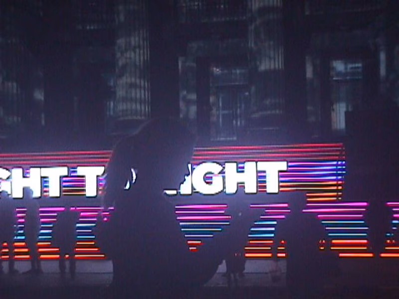 User silhouette against a vibrant, neon-lit background