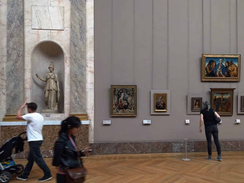 A photograph taken in a museum, capturing the artworks displayed on the walls.