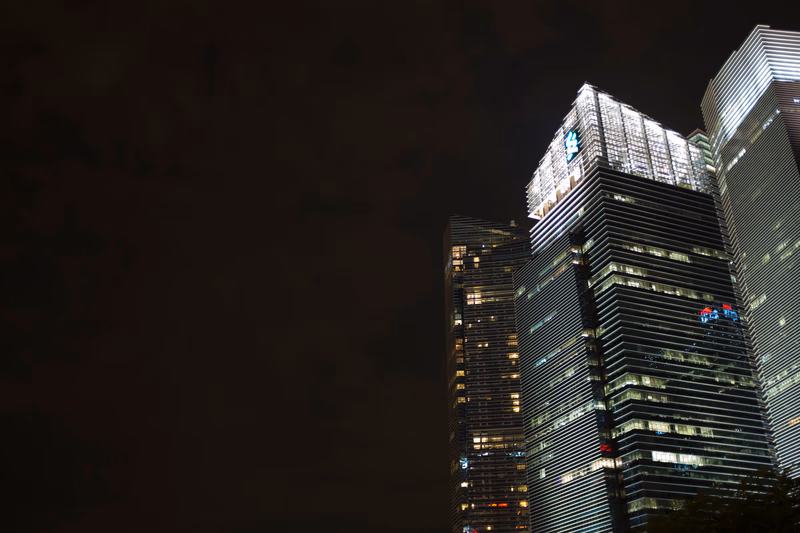 A photo of tall buildings in the city at night