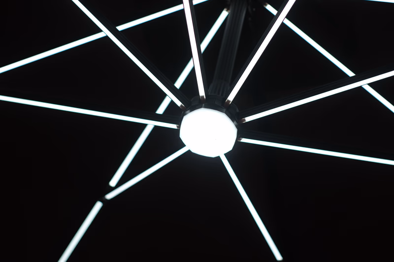 A close-up of a ceiling light fixture with multiple linear LED lights arranged in a symmetrical pattern.