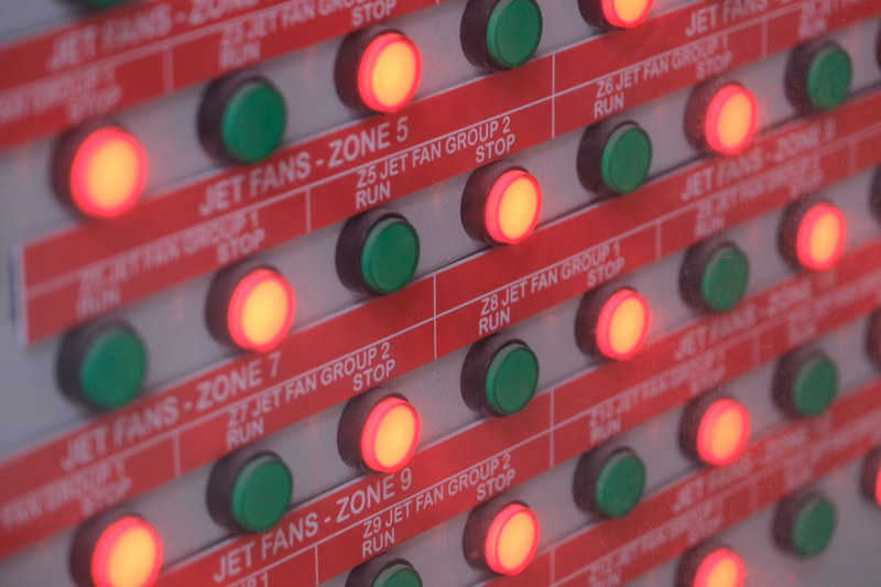 A close-up of a control panel with multiple red and green indicator lights labeled for 'JET FANS - ZONE 5' through 'JET FANS - ZONE 9'.
