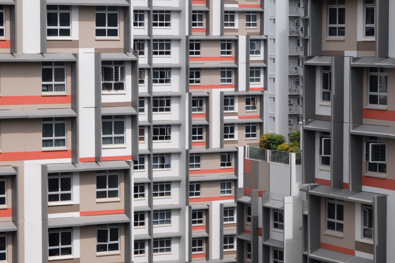 A dense collection of modern, multi-story apartment buildings with repeating window patterns and neutral-toned facades.