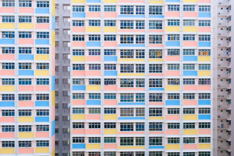 A row of colorful, multi-story apartment blocks with numerous windows dominates the frame.