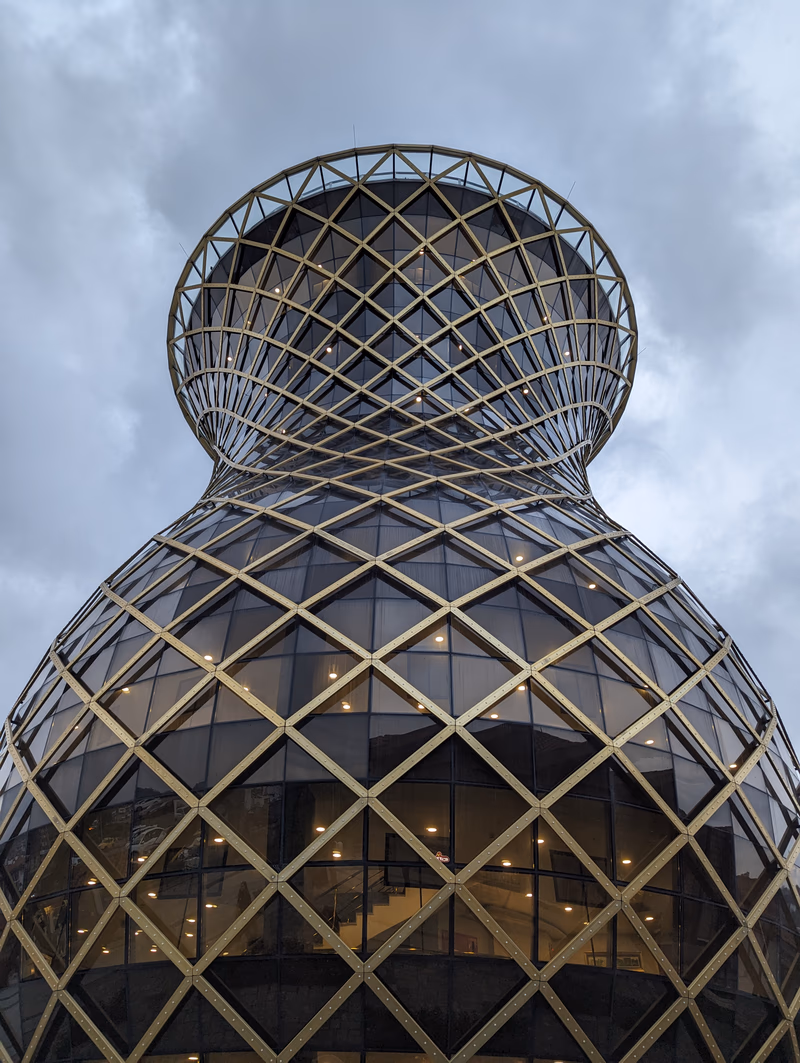 A photo of a modern, geometric building with a unique, lattice-like design.