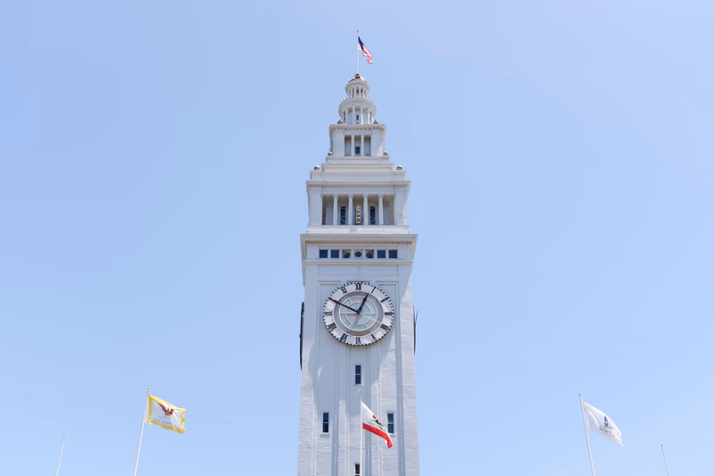 A tall clock tower with a clear blue sky in the background