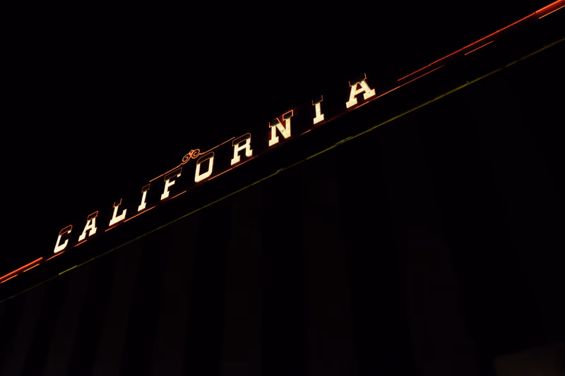 A photograph of a neon sign that reads 'California' at night in Las Vegas, Nevada, United States.