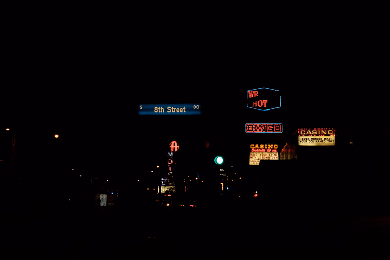 A nighttime view of 8th Street featuring illuminated signs for WR HOT, BINGO, and CASINO.